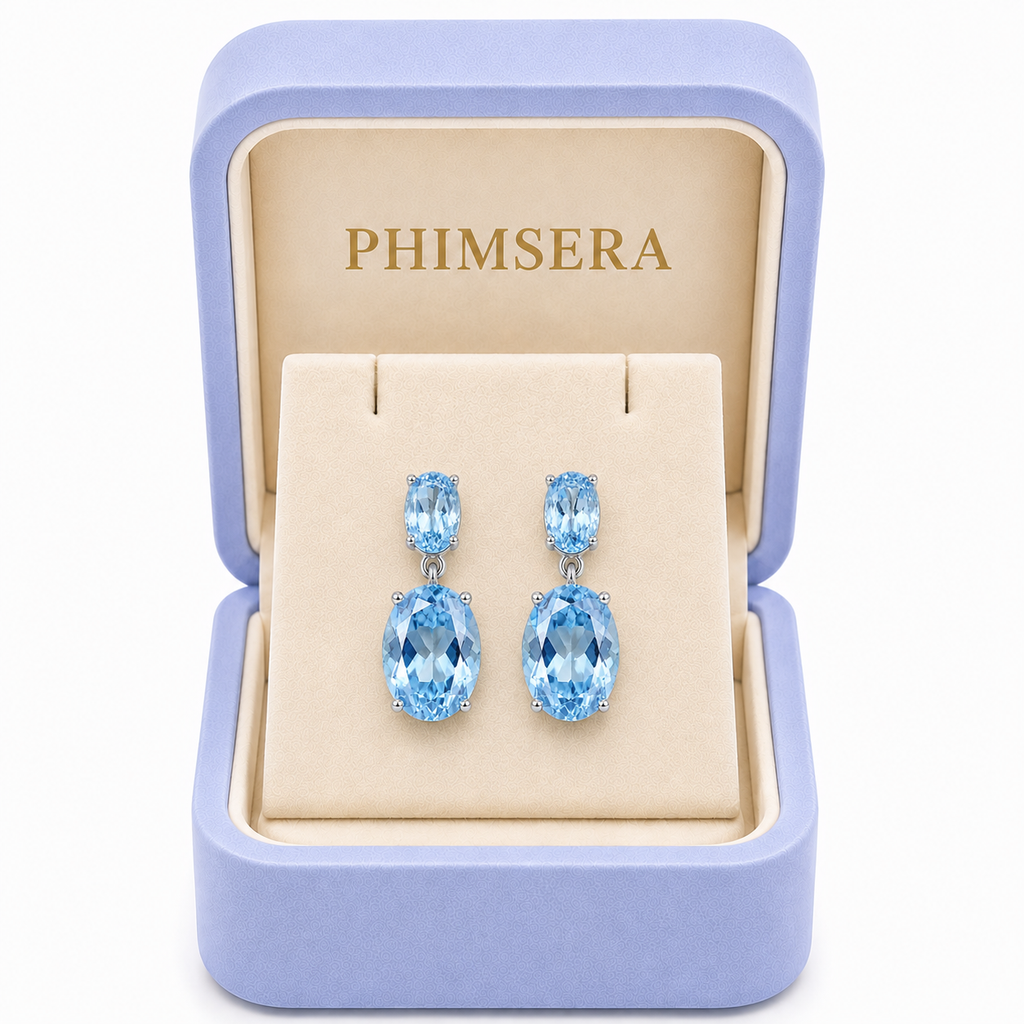 Natural Sky Blue Topaz drop earrings with 4x6mm and 8x10mm oval gemstones in a Phimsera Box