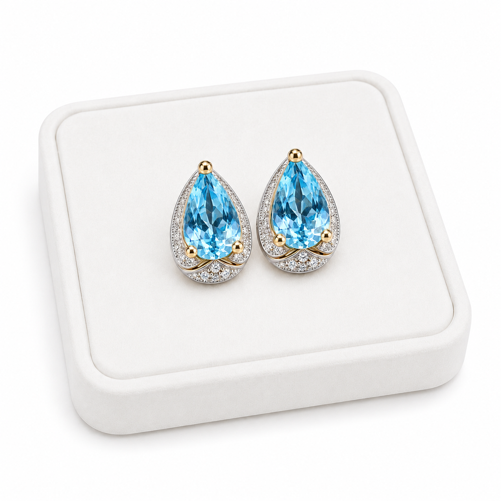 Sky Blue Topaz 4x6mm pear cut earrings displayed on a white velvet jewelry tray