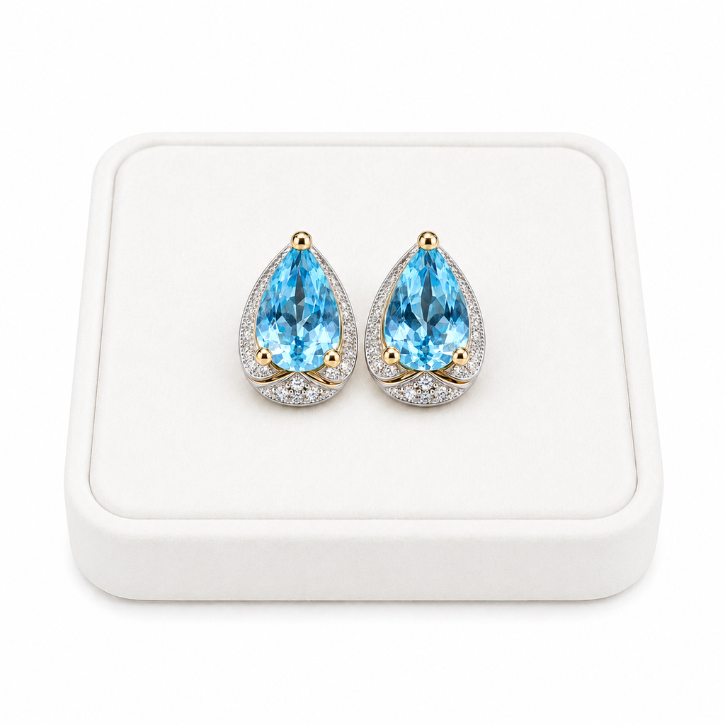 Sky Blue Topaz 4x6mm pear cut earrings displayed on a white velvet jewelry tray