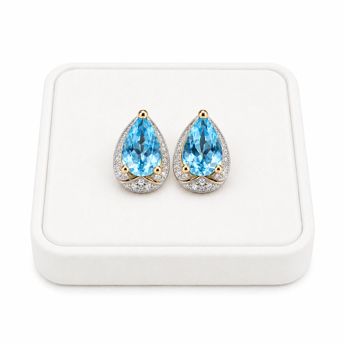 Sky Blue Topaz 4x6mm pear cut earrings displayed on a white velvet jewelry tray