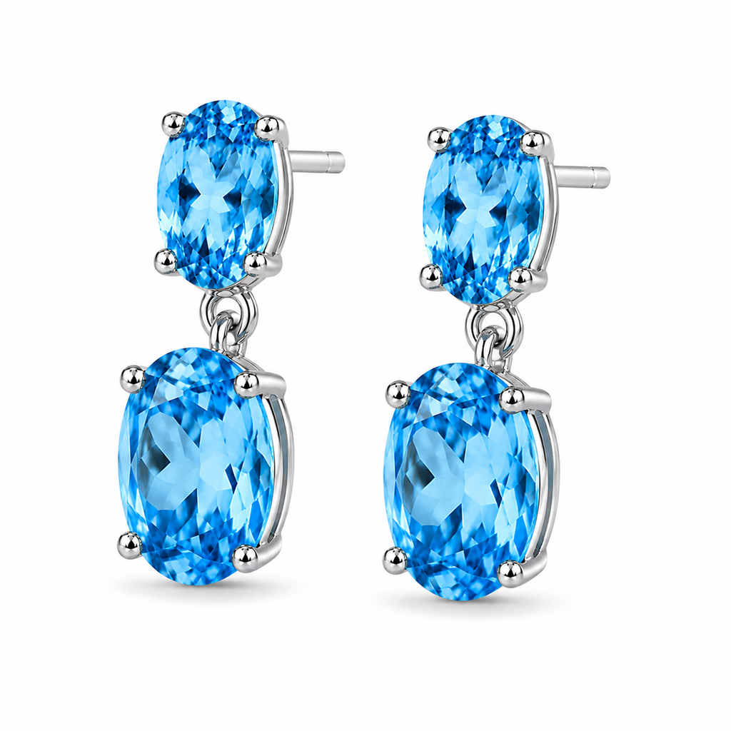Swiss Blue Topaz dangle earrings shown from a three-quarter angle with faceted oval gemstones