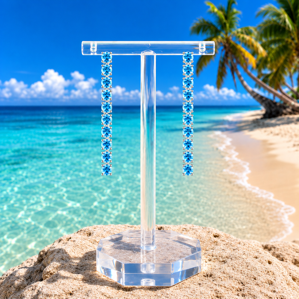 Swiss Blue Topaz dangle earrings styled in a natural beach setting
