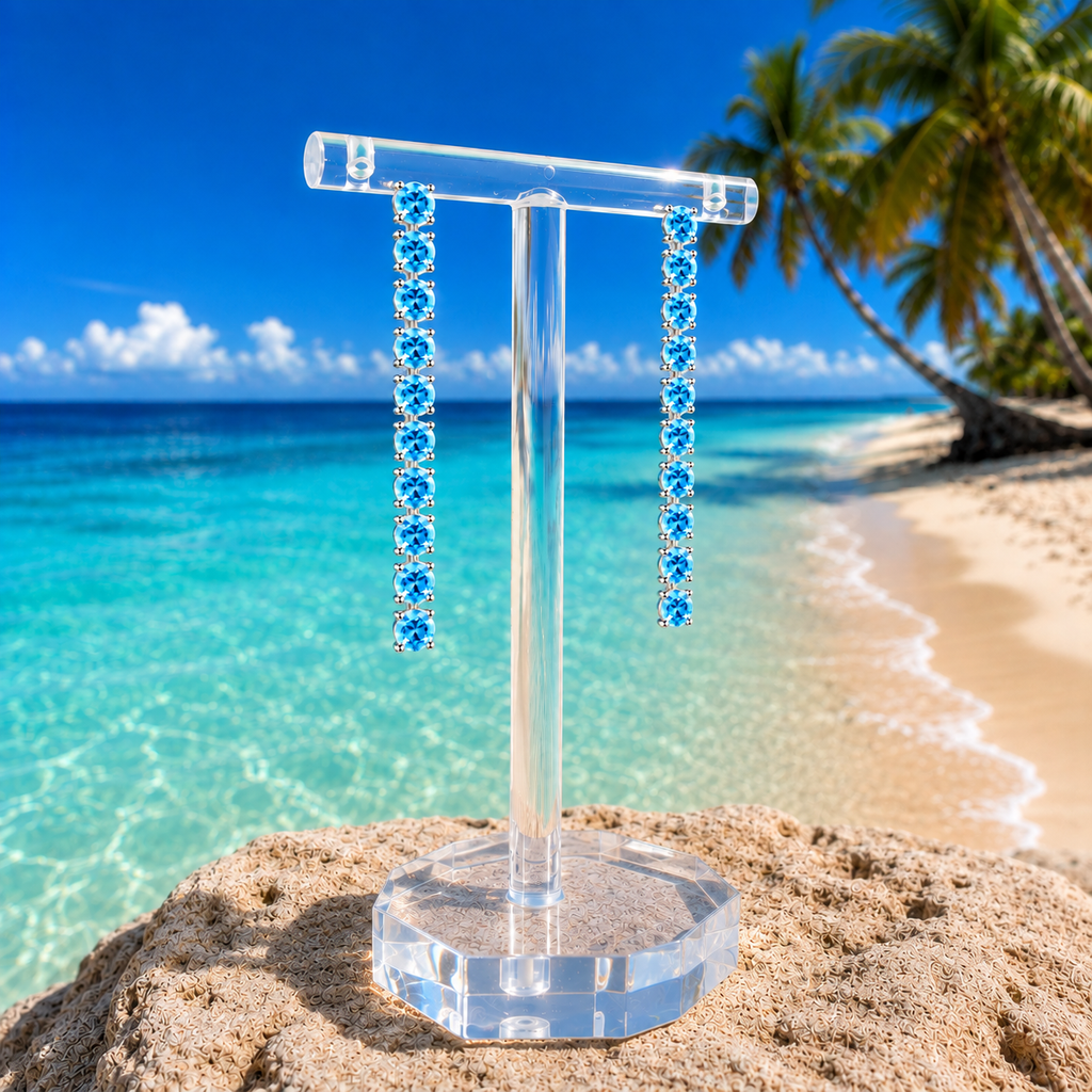 Swiss Blue Topaz dangle earrings styled in a natural beach setting