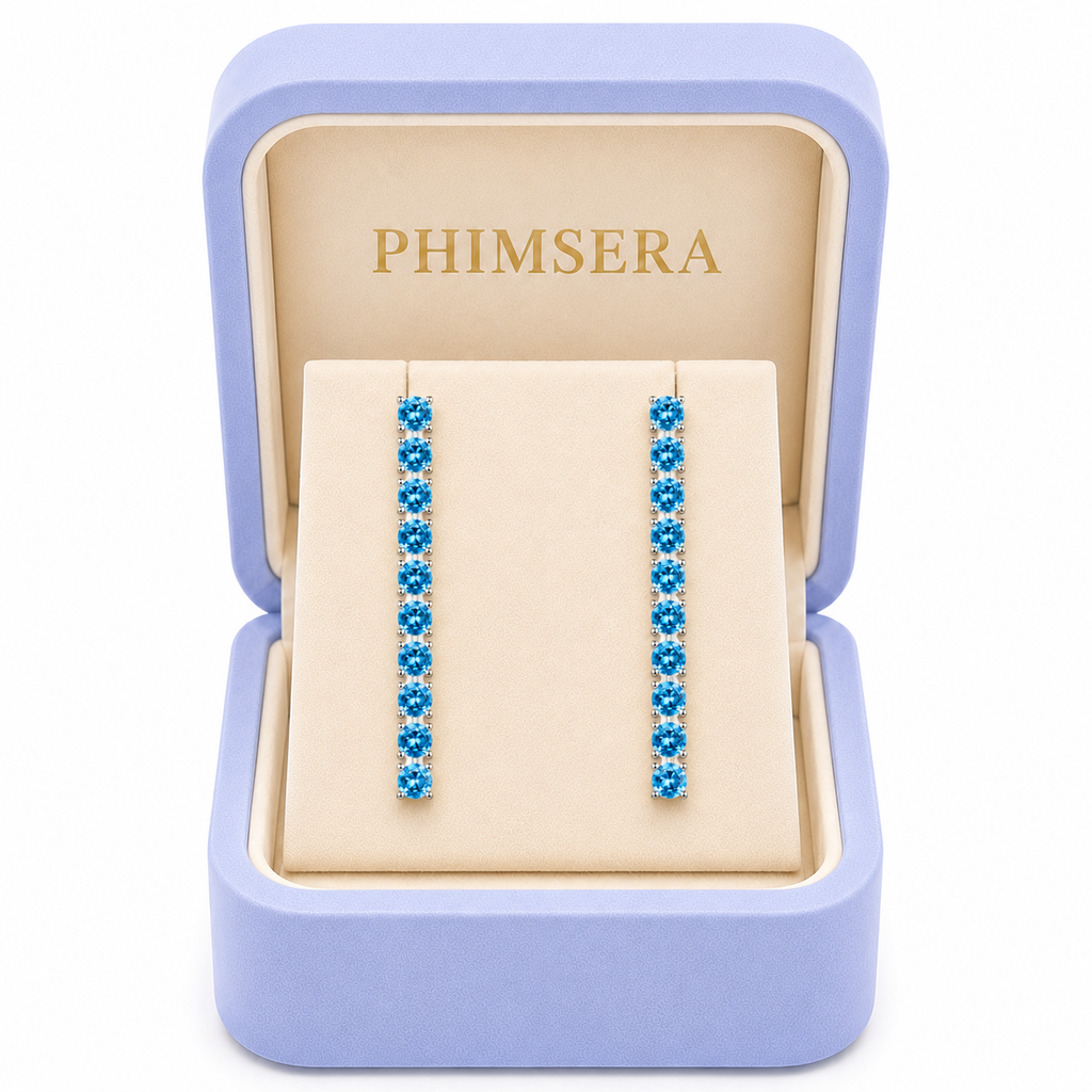 Swiss Blue Topaz dangle earrings presented in a Phimsera jewelry box