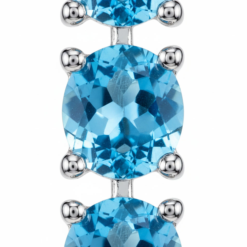 Close-up view of the faceted 3mm Swiss Blue Topaz gemstones and sterling silver settings