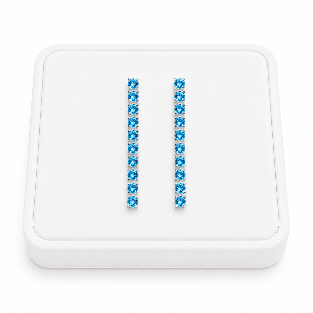 3mm Swiss Blue Topaz dangle earrings displayed on a white velvet jewelry tray