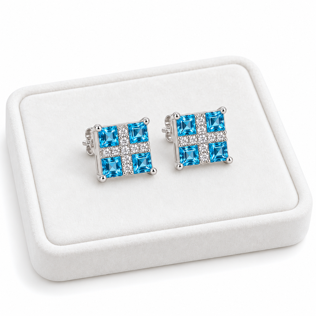 Swiss Blue Topaz stud earrings with 3mm square gemstones displayed on a white velvet tray