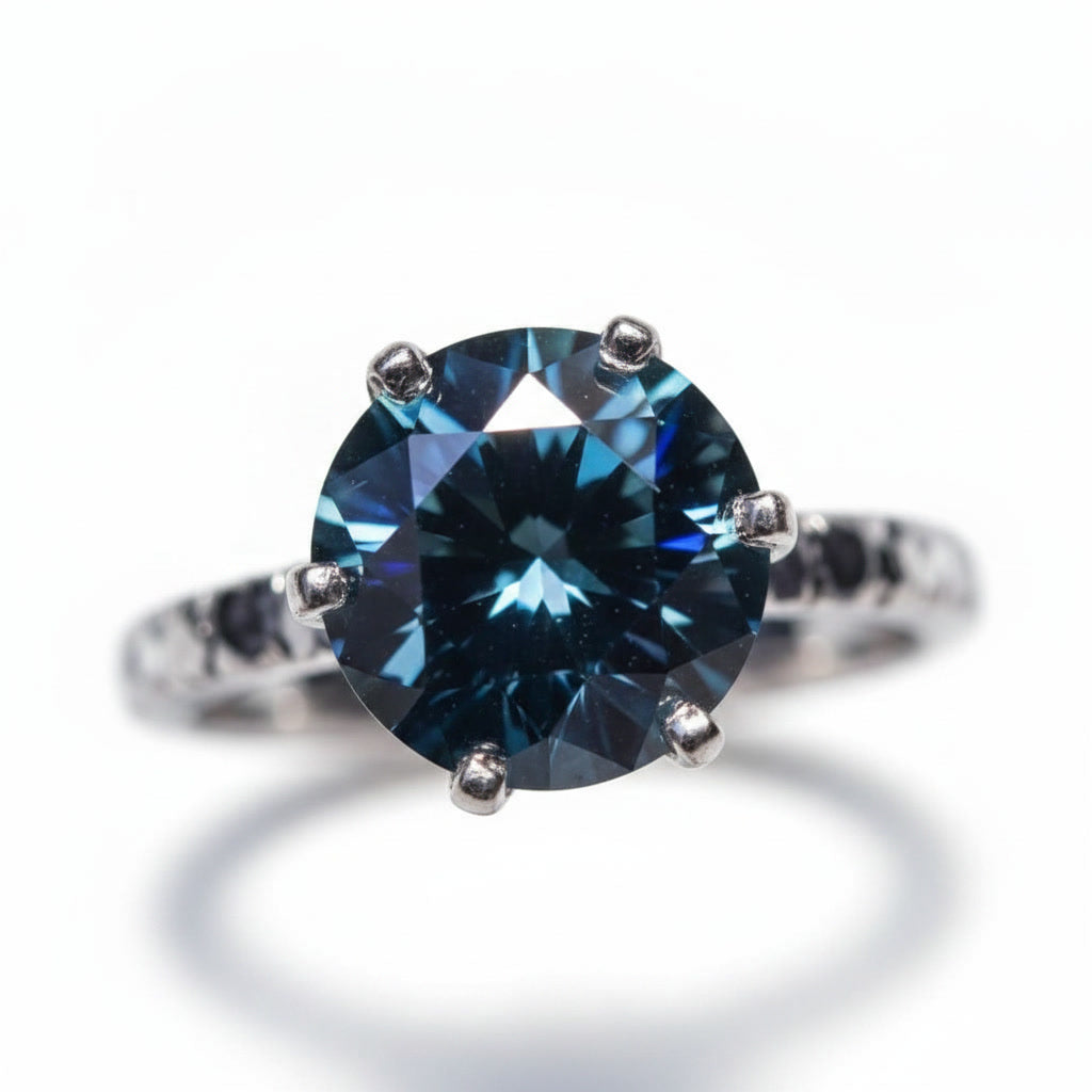 2 carat dark blue round moissanite solitaire ring in platinum plated 925 sterling silver on a white background