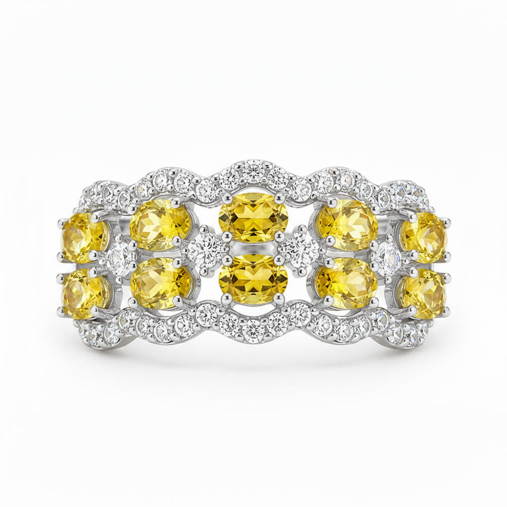 Close-up of 3x4mm oval natural yellow citrine gemstones and sparkling CZ accents