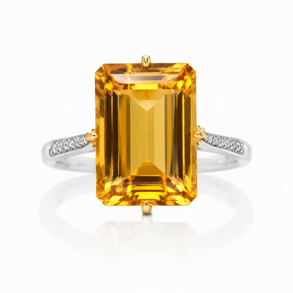 Macro close-up of 10x14mm emerald cut natural citrine showing golden step-cut facets