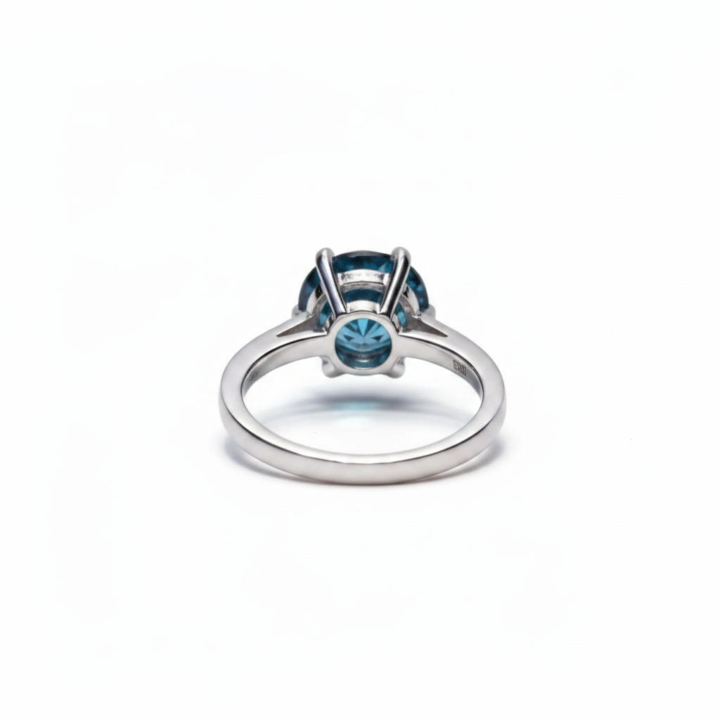 2 carat dark blue round moissanite solitaire ring in platinum plated 925 sterling silver on a white background