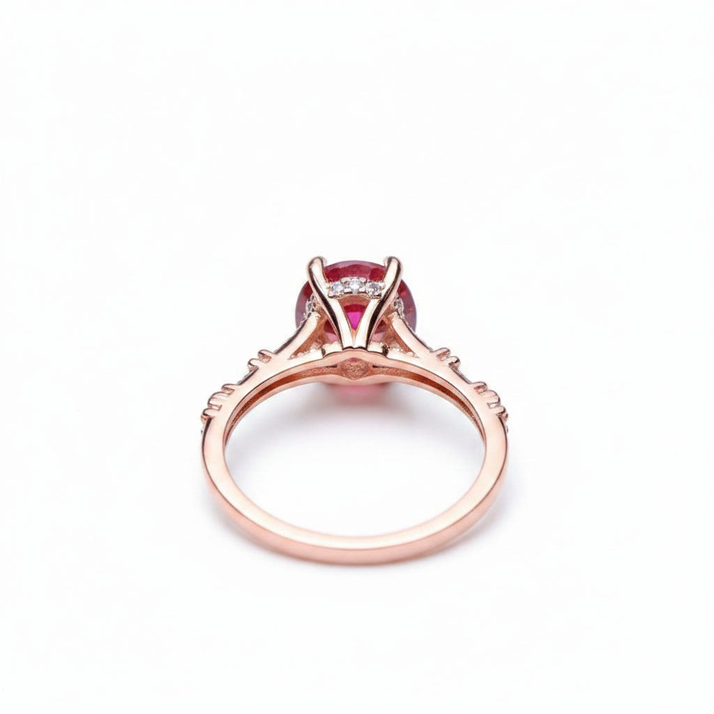 1 carat 6.5mm round Watermelon Red moissanite crown setting ring with cubic zirconia accents in rose gold plated sterling silver on a white background