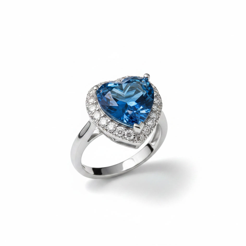 Natural London Blue Topaz heart ring featuring a 5.8 CT 10mm heart-cut gemstone surrounded by a sparkling cubic zirconia halo in sterling silver.