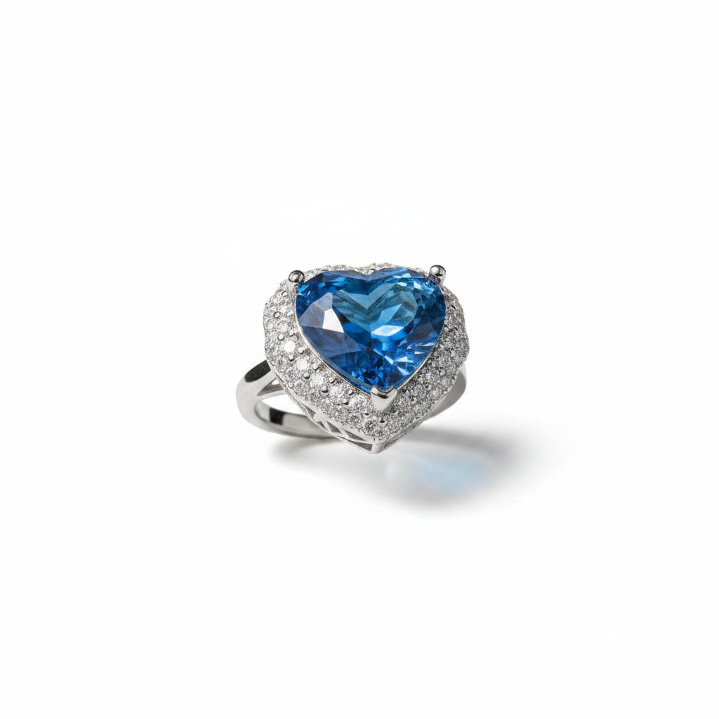 Natural London Blue Topaz heart ring featuring a 5.8 CT 10mm heart-cut gemstone surrounded by a sparkling cubic zirconia halo in sterling silver.