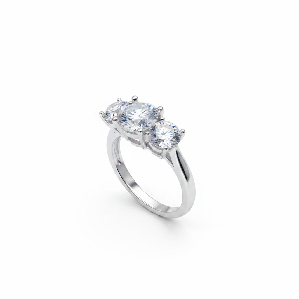 Three stone white moissanite ring featuring a 1 carat round center stone with two 0.5 carat side stones in solid sterling silver with platinum plating.