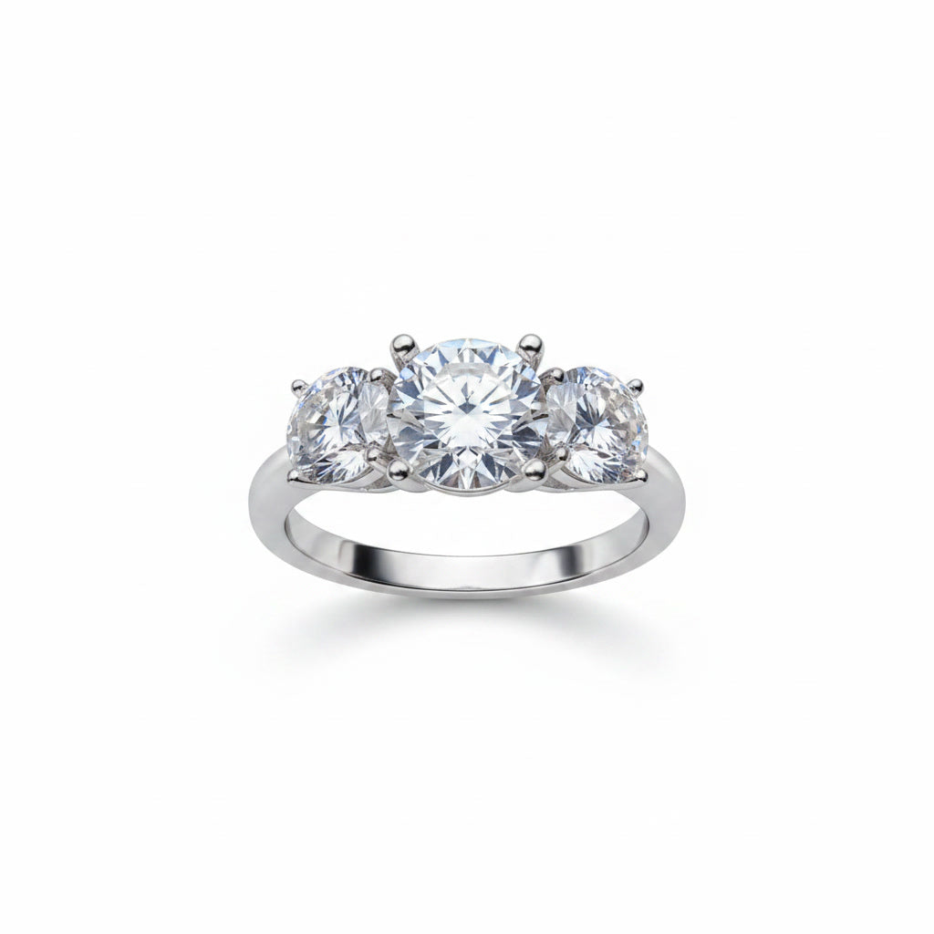 Three stone white moissanite ring featuring a 1 carat round center stone with two 0.5 carat side stones in solid sterling silver with platinum plating.