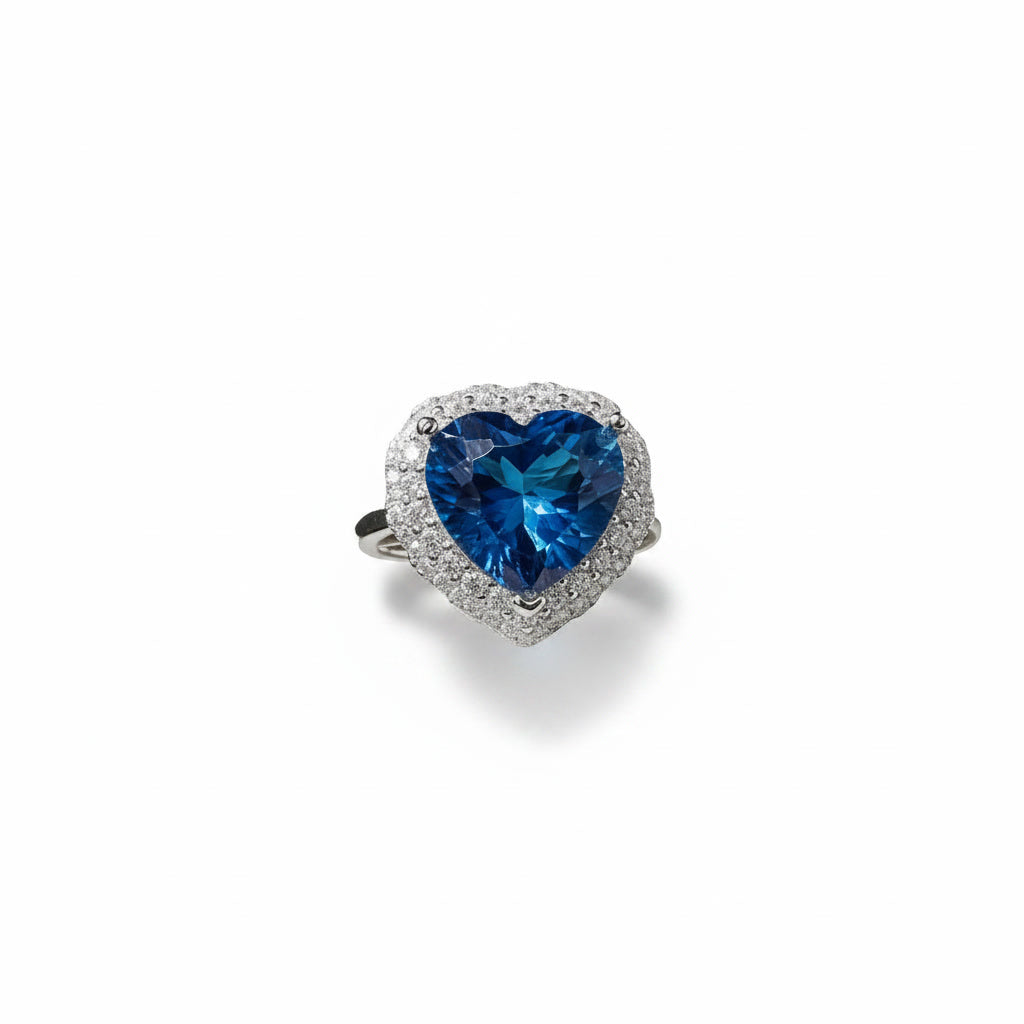 Natural London Blue Topaz heart ring featuring a 5.8 CT 10mm heart-cut gemstone surrounded by a sparkling cubic zirconia halo in sterling silver.