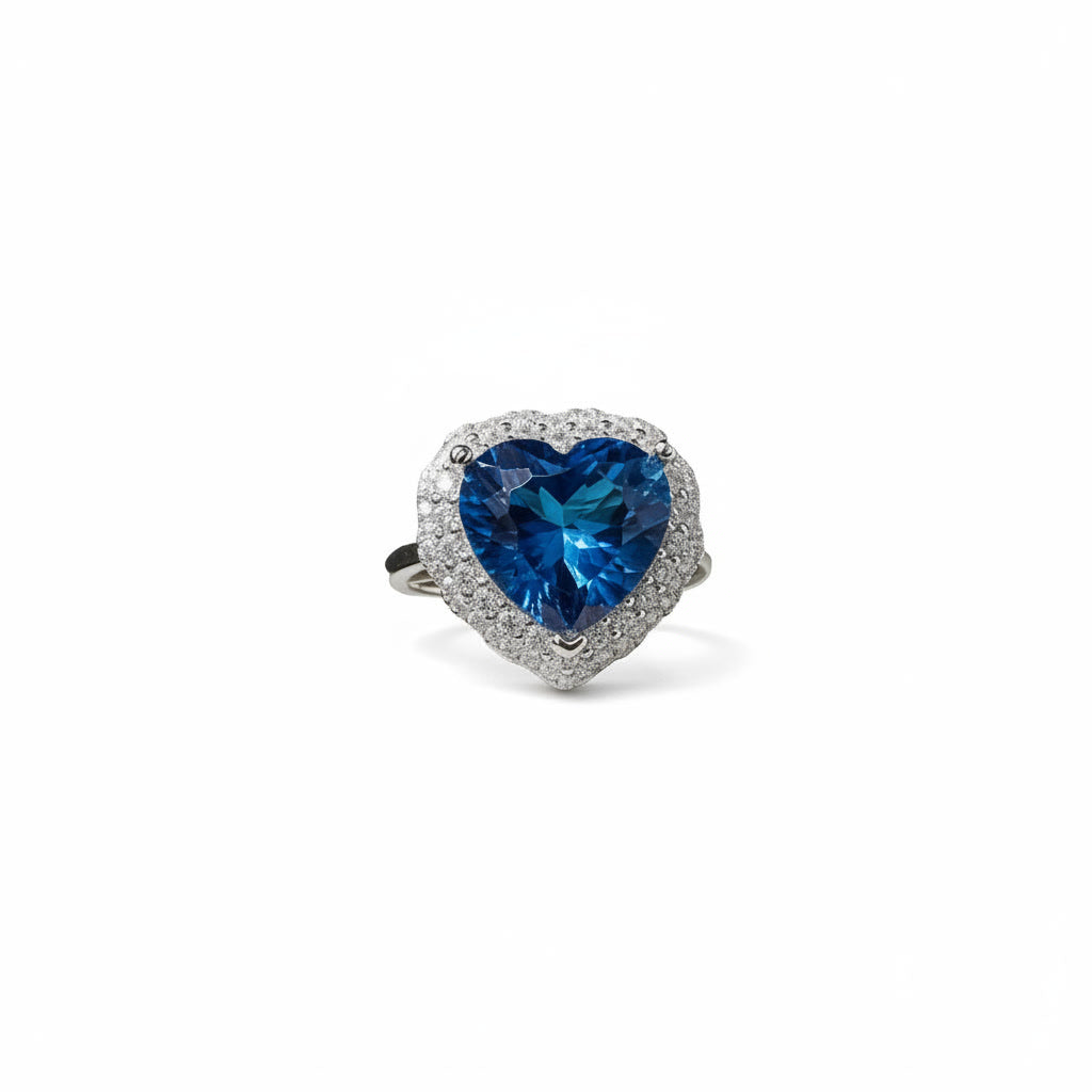 Natural London Blue Topaz heart ring featuring a 5.8 CT 10mm heart-cut gemstone surrounded by a sparkling cubic zirconia halo in sterling silver.