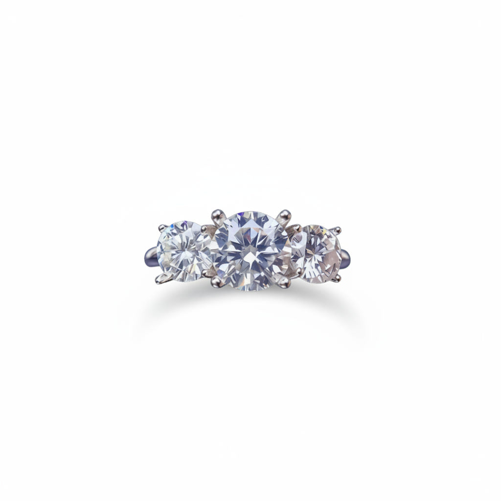 Three stone white moissanite ring featuring a 1 carat round center stone with two 0.5 carat side stones in solid sterling silver with platinum plating.