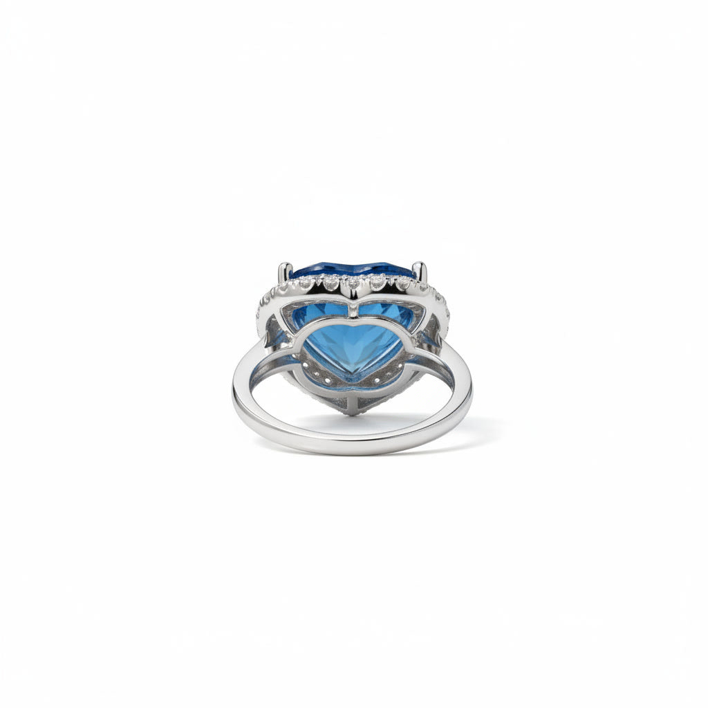 Natural London Blue Topaz heart ring featuring a 5.8 CT 10mm heart-cut gemstone surrounded by a sparkling cubic zirconia halo in sterling silver.