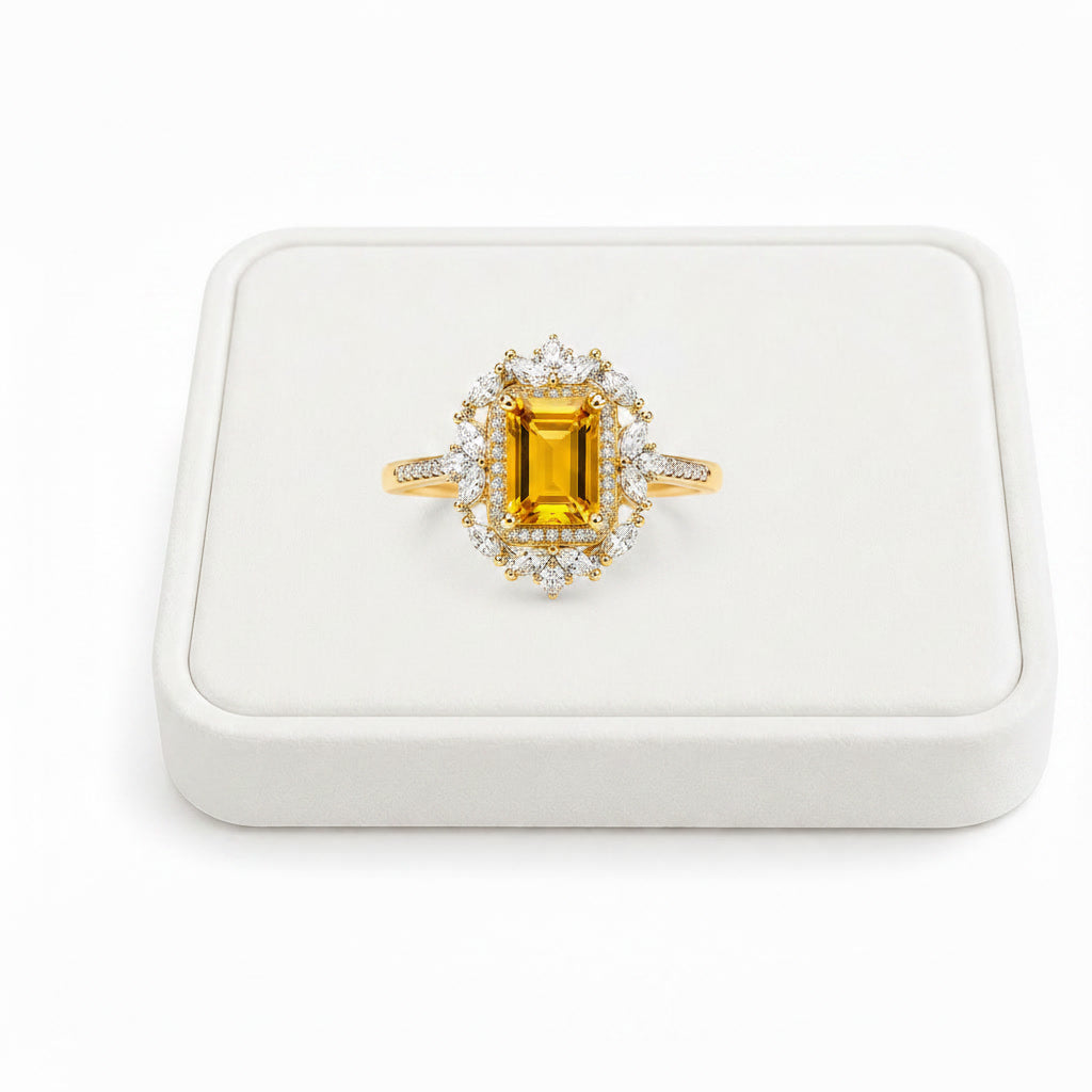 Natural citrine emerald cut ring displayed on white velvet jewelry tray