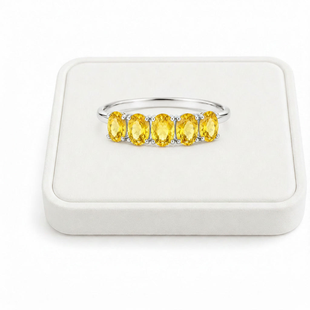 Natural five-stone citrine band displayed on white velvet jewelry tray