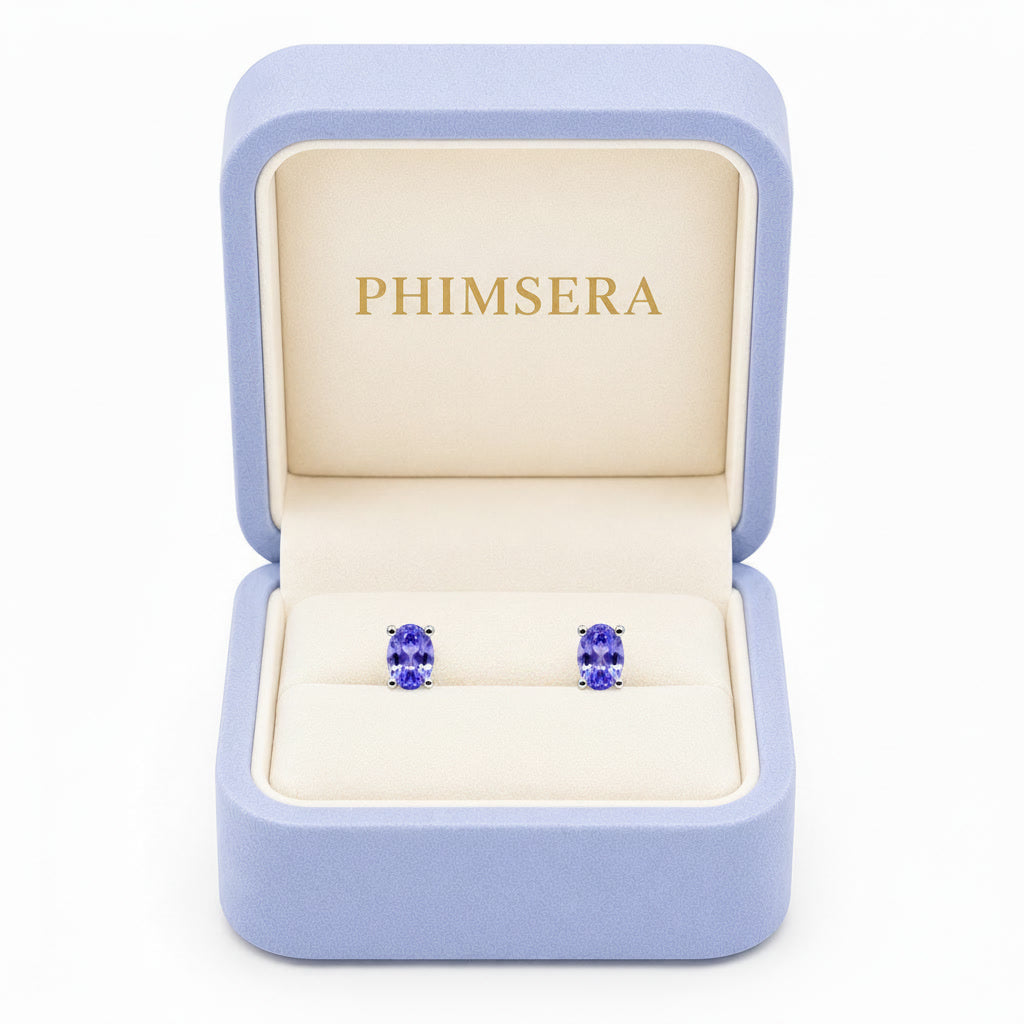 Natural Purple Tanzanite Halo Stud Earrings featuring 4x6mm oval genuine tanzanite gemstones in 925 sterling silver with sparkling cubic zirconia by Phimsera.