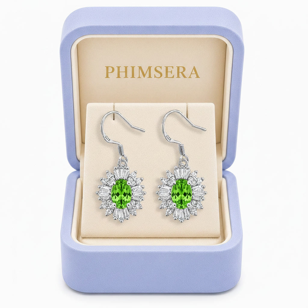 Natural 4x6mm oval tsavorite halo drop earrings crafted in 925 sterling silver with brilliant green gemstones and sparkling cubic zirconia accents in Phimsera box.