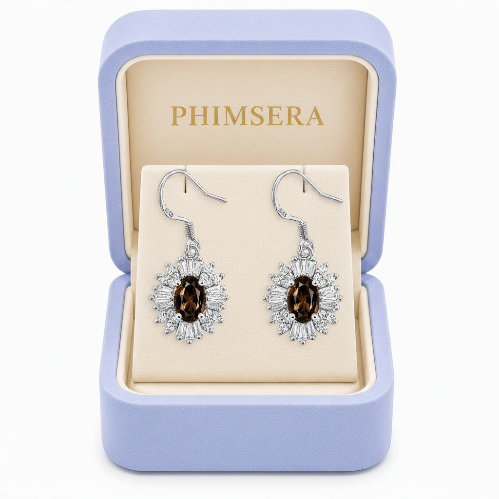 Natural 4x6mm oval smoky quartz halo drop earrings crafted in 925 sterling silver with sparkling cubic zirconia accents.