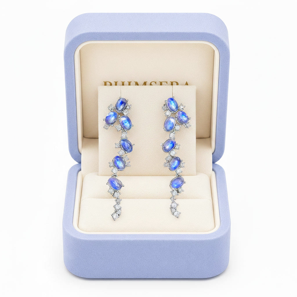 Natural Blue Moonstone stud earrings featuring genuine 4x6mm oval moonstones surrounded by high quality cubic zirconia in 925 sterling silver.