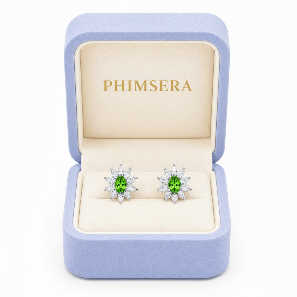 Natural 4x6mm oval tsavorite halo stud earrings in 925 sterling silver with marquise cubic zirconia floral halo on a white background