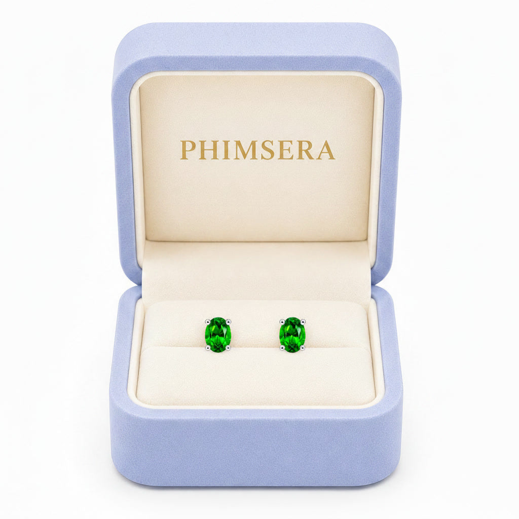 Natural 4x6mm oval chrome diopside stud earrings in 925 sterling silver on white background