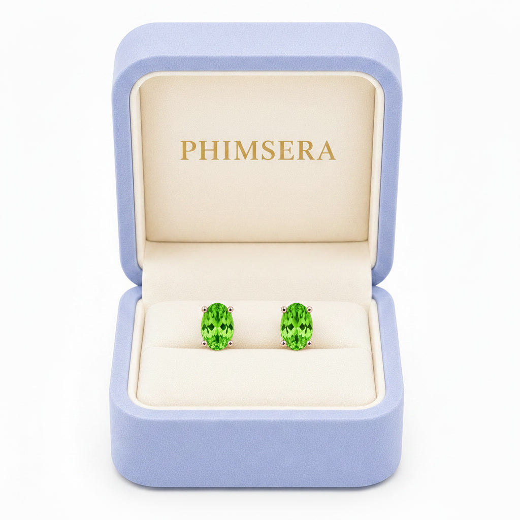 Natural 4x6mm oval tsavorite garnet stud earrings in 925 sterling silver solitaire setting on white background