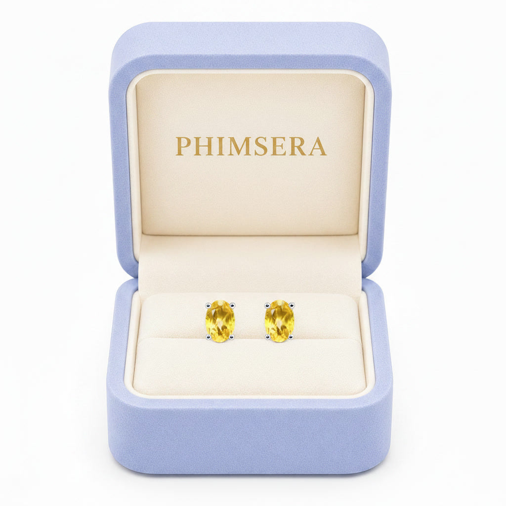 Natural 4x6mm oval citrine stud earrings in platinum plated 925 sterling silver front view