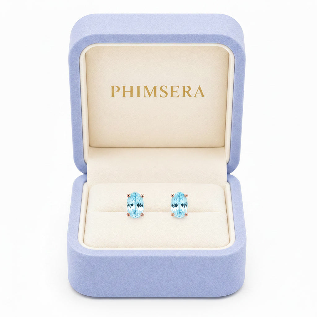 Natural 4x6mm oval aquamarine stud earrings in 925 sterling silver on a white background
