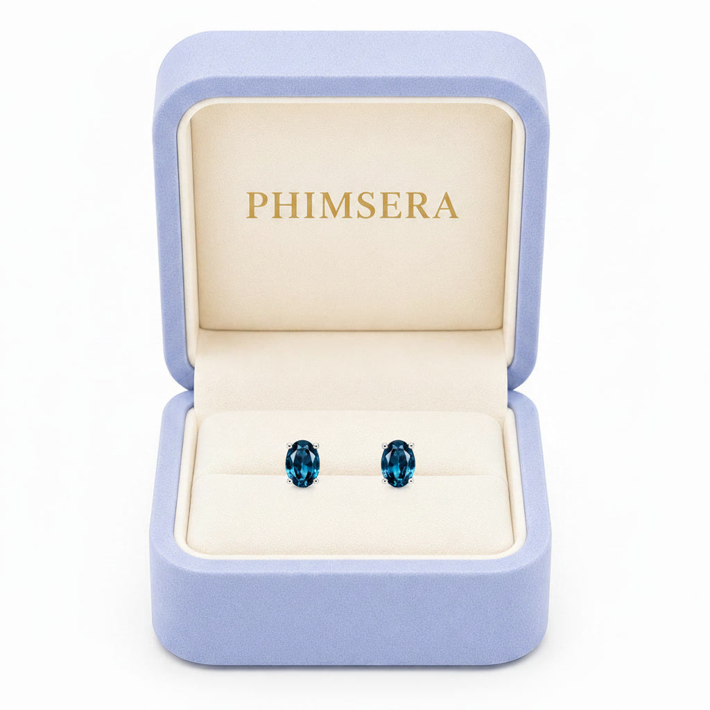 Natural 4x6mm oval London Blue Topaz solitaire stud earrings in 925 sterling silver with platinum plated finish