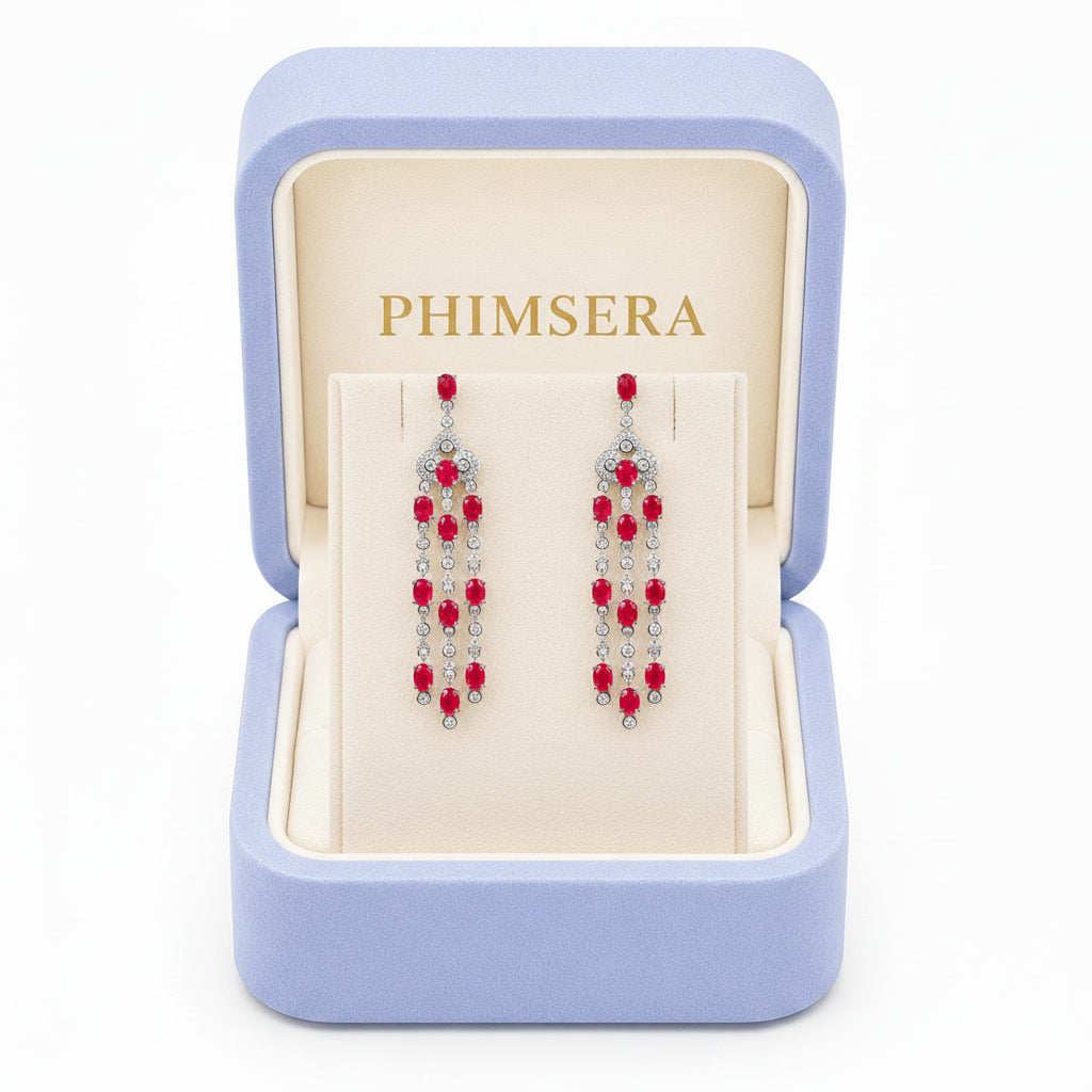 Natural ruby chandelier drop earrings featuring genuine 3x4mm oval rubies, cubic zirconia accents, and platinum plated 925 sterling silver on a white background.