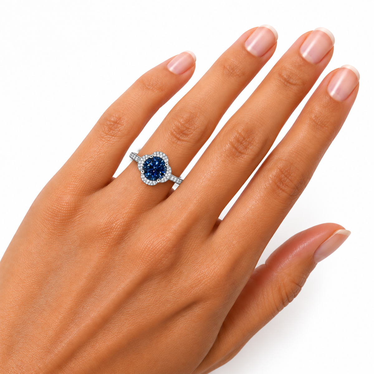 Phimsera 8mm deep blue moissanite floral halo ring worn on a woman's ring finger, displaying the rich navy blue center gemstone, sparkling cubic zirconia floral setting and sterling silver band.