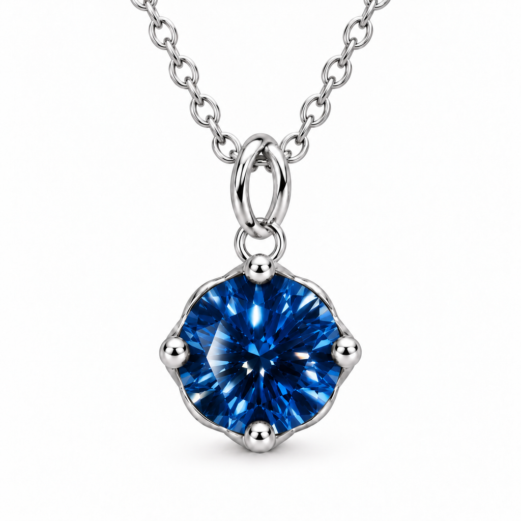 Frontal close-up of a 2 carat royal blue moissanite solitaire pendant with VVS1 clarity, four rounded silver prongs, brilliant sapphire-blue reflections, a polished oval bail, and a sterling silver chain.