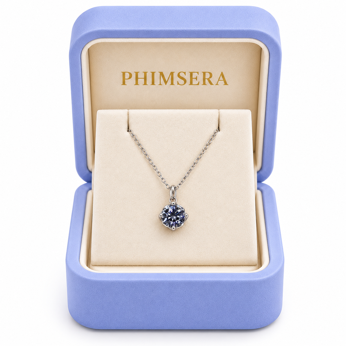 2 carat gray moissanite solitaire pendant necklace displayed inside an open periwinkle Phimsera jewelry gift box with an ivory interior, gold Phimsera branding, and a white studio background.