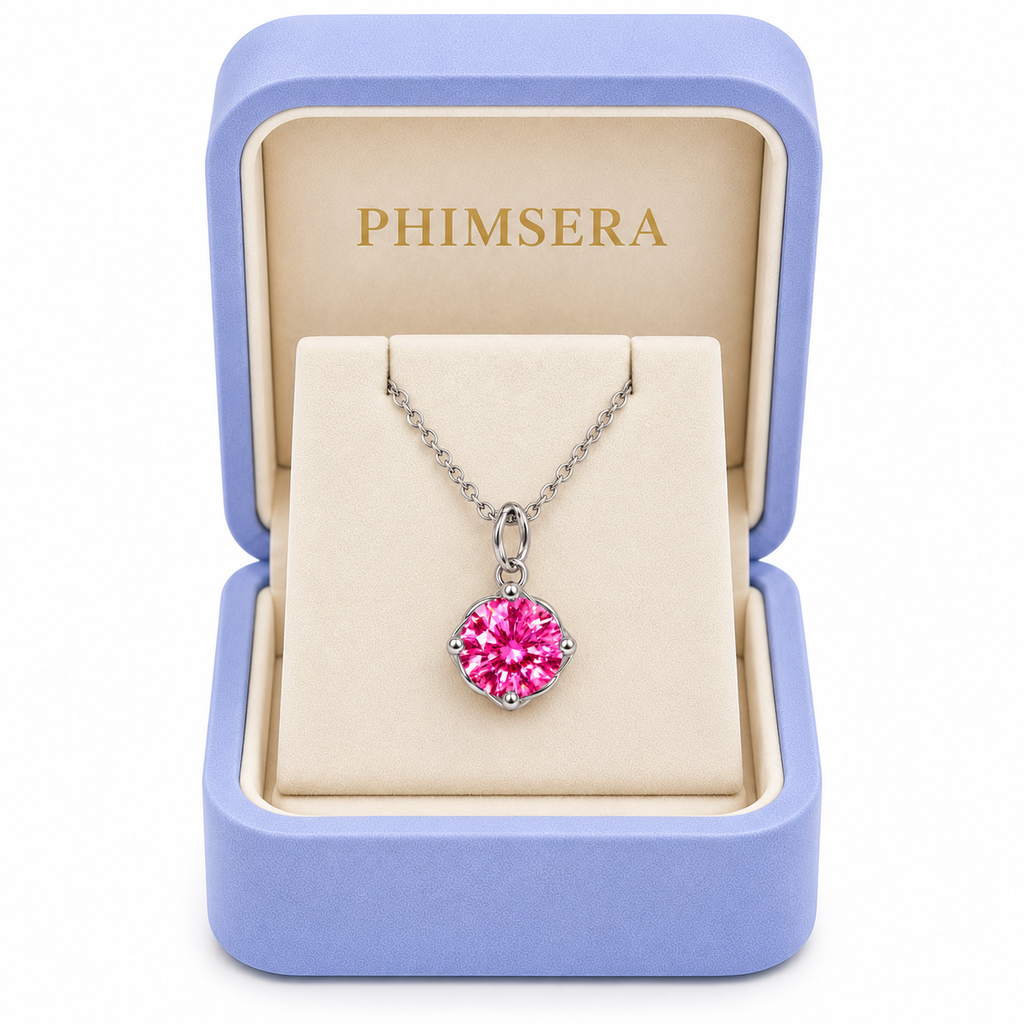 2 carat pink moissanite solitaire necklace displayed inside an open periwinkle Phimsera jewelry gift box with an ivory interior, gold Phimsera logo, and brilliant 8mm fuchsia-pink gemstone.