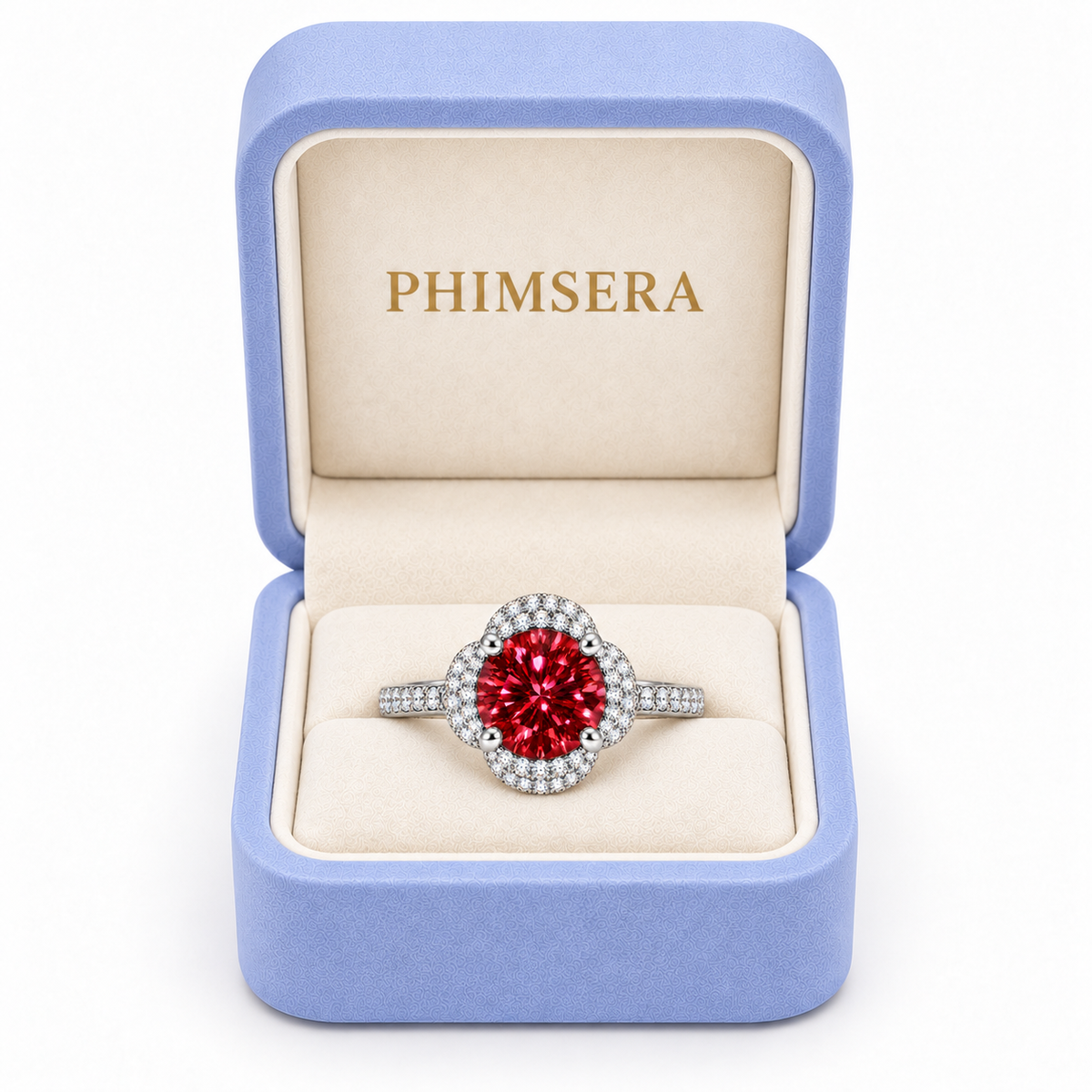 Brilliant red moissanite floral halo ring displayed inside a periwinkle Phimsera jewelry gift box with an ivory velvet interior and gold PHIMSERA lettering against a clean white background.