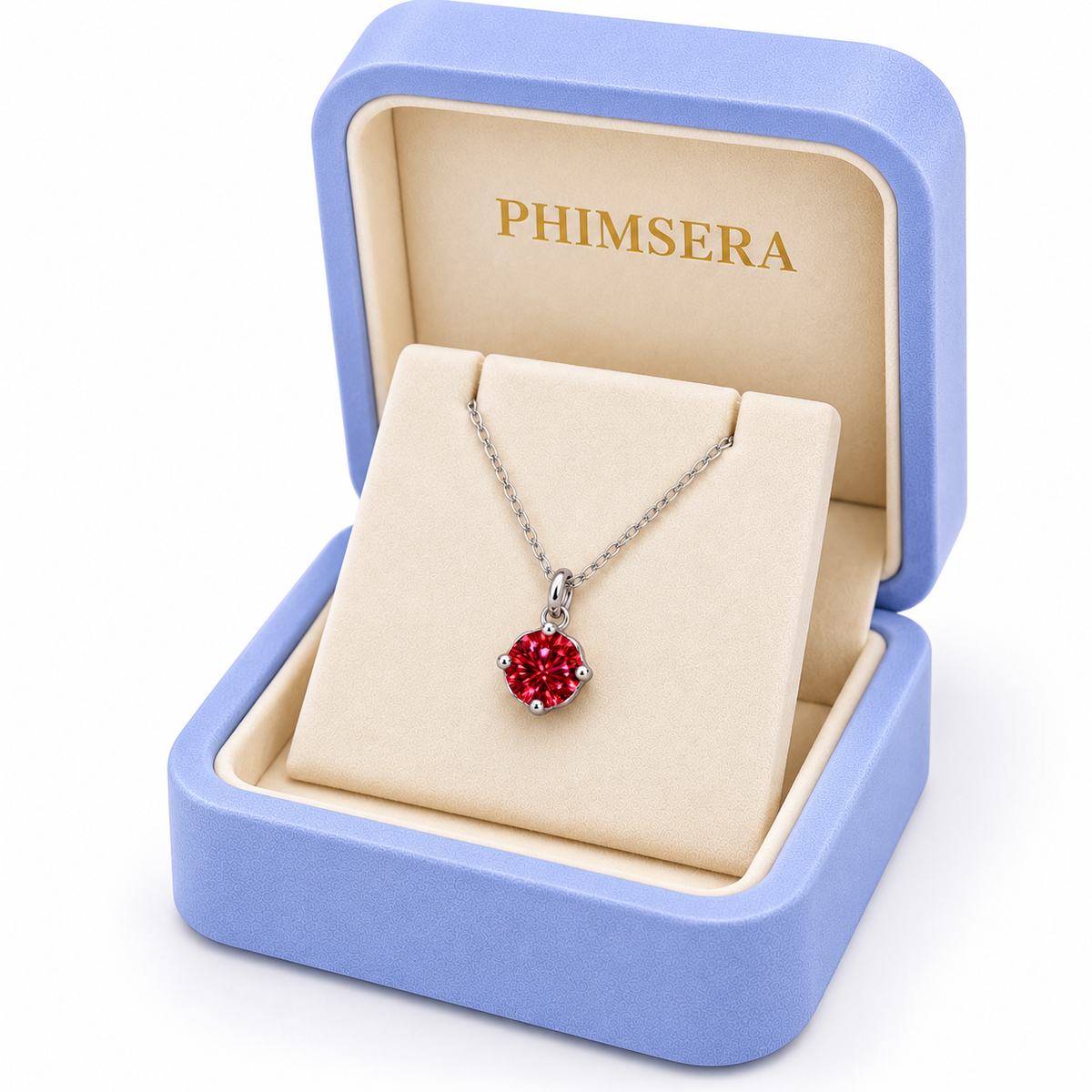 Angled view of a periwinkle Phimsera jewelry gift box containing an 8mm crimson-red moissanite solitaire pendant necklace with a delicate silver chain, ivory jewelry insert, and gold Phimsera branding.