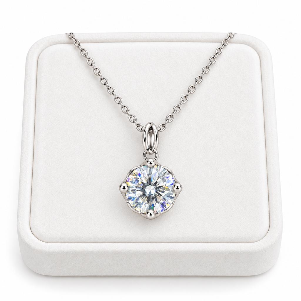 2 carat white moissanite solitaire necklace arranged on a premium white velvet jewelry tray with a delicate sterling silver chain and brilliant round gemstone.