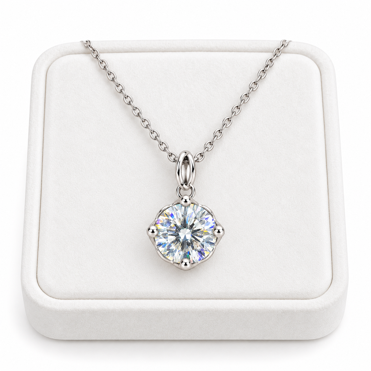 2 carat white moissanite solitaire necklace arranged on a premium white velvet jewelry tray with a delicate sterling silver chain and brilliant round gemstone.