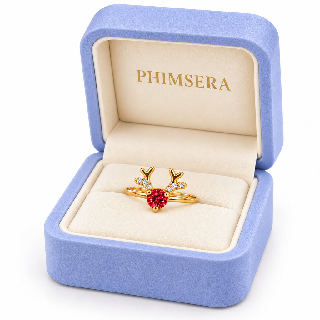 Angled view of a periwinkle Phimsera jewelry gift box displaying a delicate gold reindeer antler ring with a brilliant 4mm round crimson-red moissanite gemstone and sparkling CZ accents.