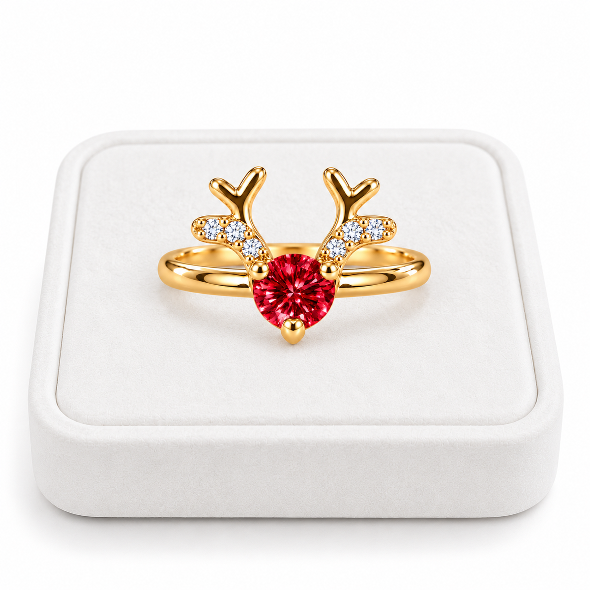 Gold Christmas reindeer antler ring featuring a brilliant 4mm crimson-red moissanite gemstone displayed on a premium white velvet jewelry tray against a pure white background.