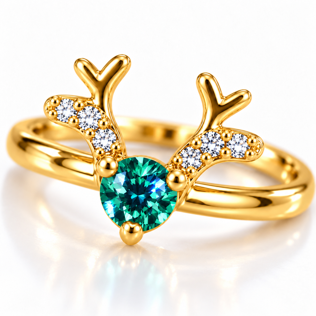 Macro close-up of a 4mm round brilliant-cut teal-green moissanite gemstone held by three polished gold prongs between symmetrical reindeer antlers decorated with clear cubic zirconia.