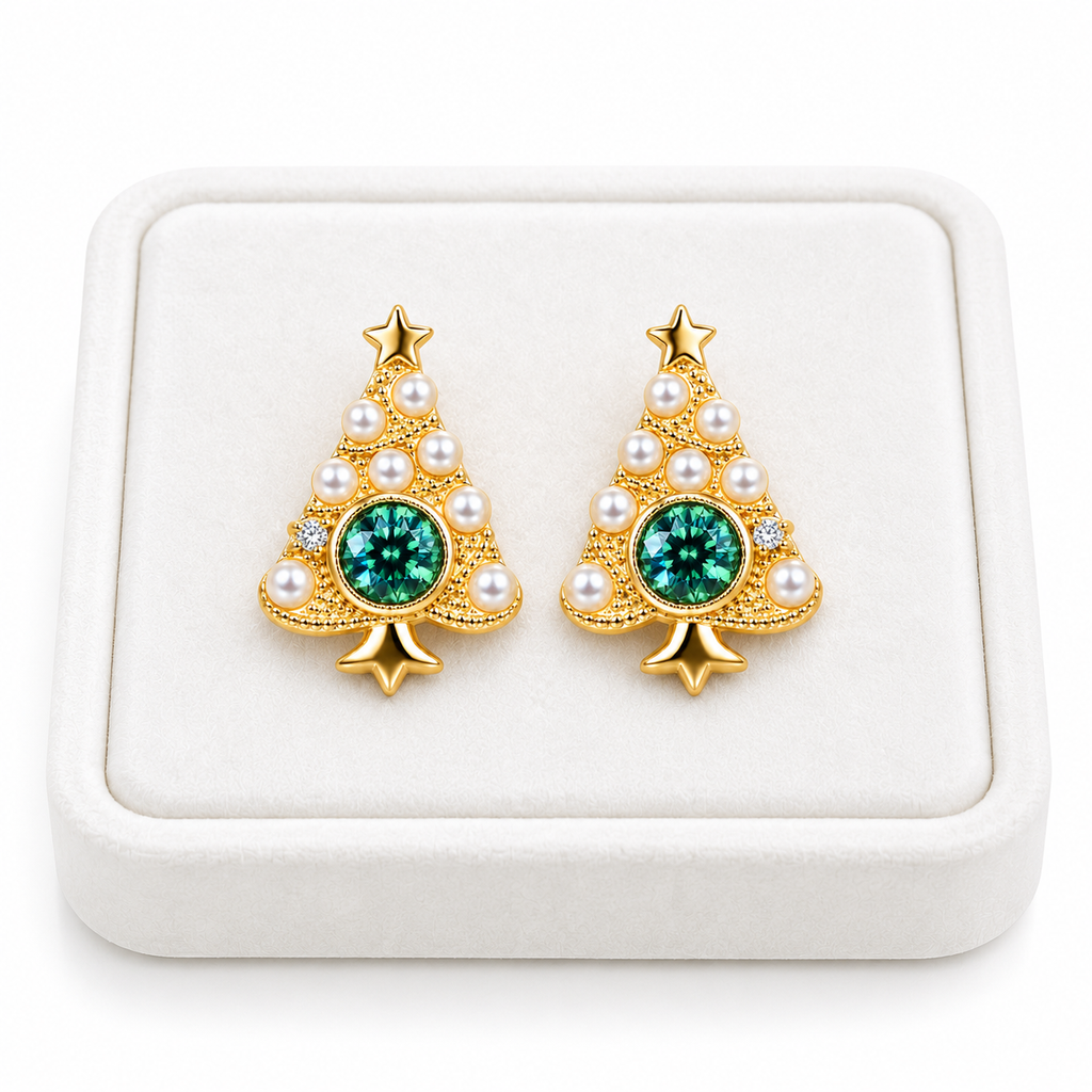 Pair of green moissanite Christmas tree earrings displayed on a flat white velvet jewelry tray against a white background.