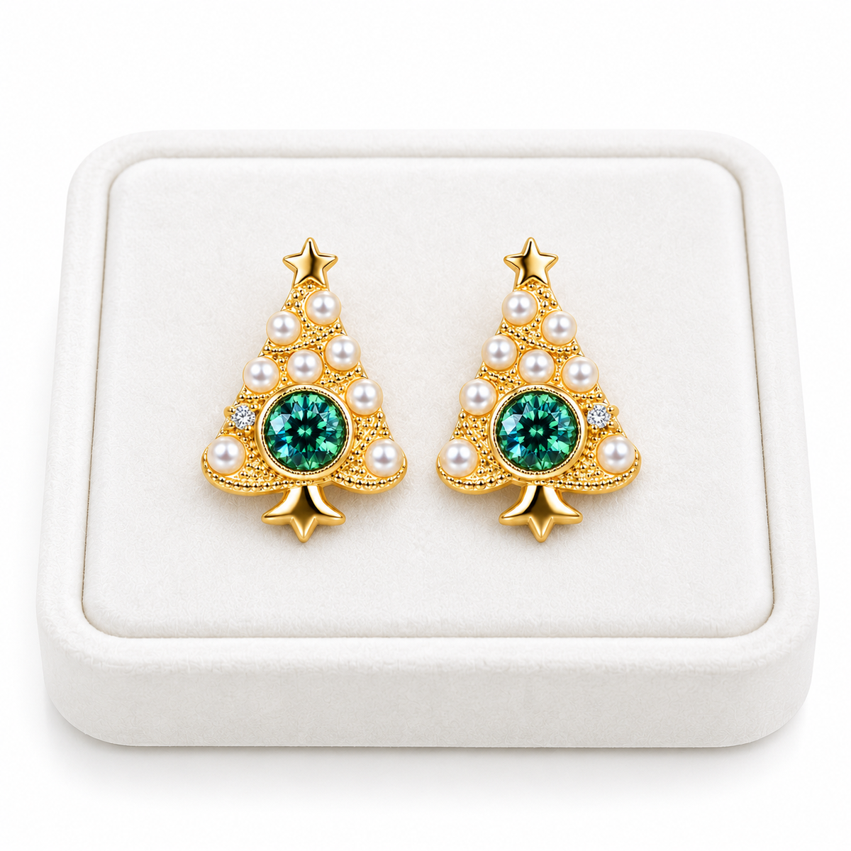 Pair of green moissanite Christmas tree earrings displayed on a flat white velvet jewelry tray against a white background.